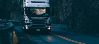 Truck driving on darkened road