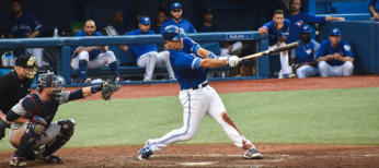 Baseball player swinging at pitch